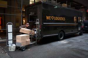 A United Parcel Service (UPS) delivery person prepares to deliver packages in the Manhattan borough of New York